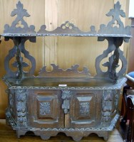Lot 1200 - An early 20th century carved oak two-tier wall...
