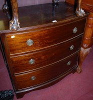 Lot 1209 - A mahogany bowfront chest of three long drawers
