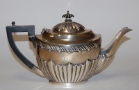 Lot 193 - An Edwardian silver teapot of half-gadrooned...