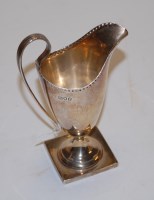 Lot 209 - An Edwardian silver helmet shaped cream jug,...