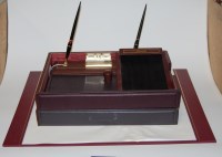 Lot 96 - A modern red leather bound desk set to include;...