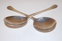 Lot 254 - A pair of Arts & Crafts hammered silver spoons,...