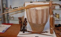 Lot 300 - A large tribal hide covered drum; together...