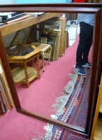 Lot 1071 - A modern faux mahogany framed wall mirror,...