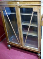 Lot 1089 - A 1930s oak ledgeback double door glazed...