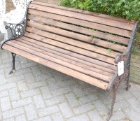 Lot 1120 - A black painted cast metal and pine slatted...