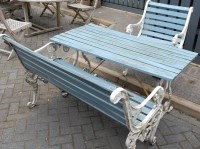 Lot 1129 - A painted cast metal ended and teak slatted...