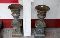 Lot 1134 - A pair of cast iron campagna pedestal garden...