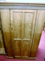 Lot 1139 - A reconstituted pine single door wardrobe,...