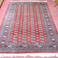 Lot 1148 - A Persian woollen Bokhara rug having four rows...