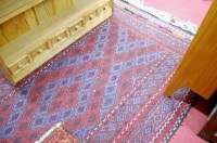 Lot 1150 - A Persian woollen kilim rug, having a blue and...