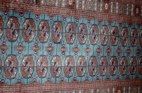Lot 1152 - A Persian woollen Bokhara hall runner having a...