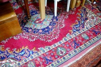 Lot 1153 - A Caucasian woollen carpet, the red ground...