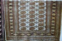 Lot 1157 - A Persian woollen Bokhara rug having three...