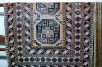 Lot 1158 - A Caucasian woollen rug decorated with three...