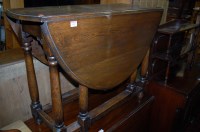 Lot 1267 - An early 20th century oak drop leaf dining...