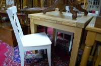 Lot 1281 - A contemporary blond oak drawleaf dining table;...