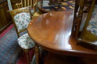 Lot 1284 - A reproduction flame mahogany extending dining...
