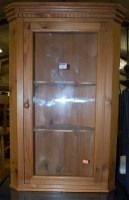 Lot 1303 - A small modern pine single door glazed hanging...