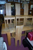 Lot 1322 - A contemporary blond oak dining table;...
