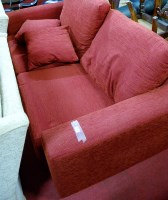 Lot 1357 - A modern red upholstered two-seater sofa