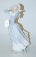 Lot 23 - A large Lladro figure of a girl in standing...