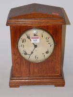 Lot 109 - An early 20th century oak cased mantel clock...