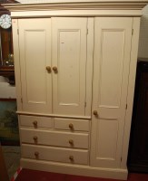 Lot 1121 - A modern cream painted pine wardrobe, the twin...