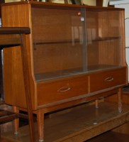 Lot 1261 - A 1970s teak display cabinet having twin...