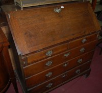 Lot 1277 - A George III oak slopefront writing bureau,...