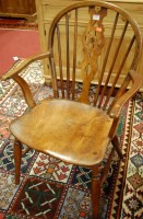 Lot 1365 - A 19th century elm wheelback single elbow chair