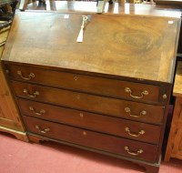 Lot 1414 - A George III mahogany slopefront four drawer...