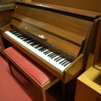 Lot 1419 - A 1970s teak framed upright piano by Kastner,...