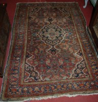 Lot 1427 - A Persian hand-woven red ground rug