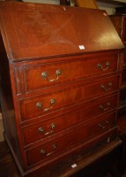 Lot 1434 - A reproduction mahogany slopefront four drawer...