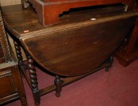Lot 1435 - A 1930s oak barleytwist dropleaf dining table,...