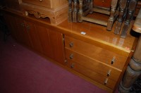 Lot 1452 - A 1970s teak low double door side cupboard,...
