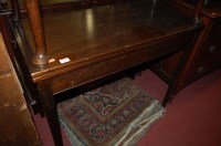 Lot 1426 - A mahogany fold-over games table, raised on...