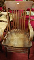 Lot 1368 - A 1930s oak slatback open elbow chair, having...