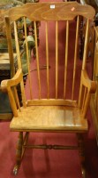 Lot 1376 - A stained beech stickback rocking elbow chair;...