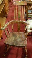 Lot 1379 - A provincial stained elm rocking Windsor type...