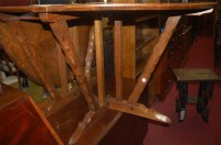 Lot 1222 - An Arts & Crafts oak dropleaf dining table,...