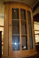 Lot 1193 - An elm bowfront single door glazed hanging...