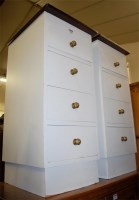 Lot 1225 - A pair of white painted four drawer bedside...