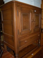 Lot 1226 - An Ercol light elm double door side cupboard,...