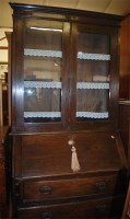 Lot 1252 - An early 20th century oak bureau bookcase,...