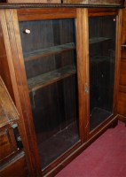 Lot 1254 - An Edwardian walnut double door glazed...
