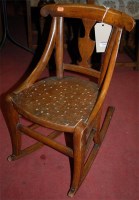 Lot 1258 - A 19th century fruitwood childs rocking chair...