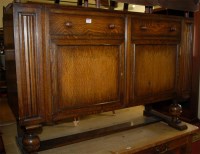 Lot 1262 - A 1930s moulded oak ledgeback sideboard