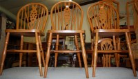 Lot 1273 - A set of four modern beech wheelback kitchen...